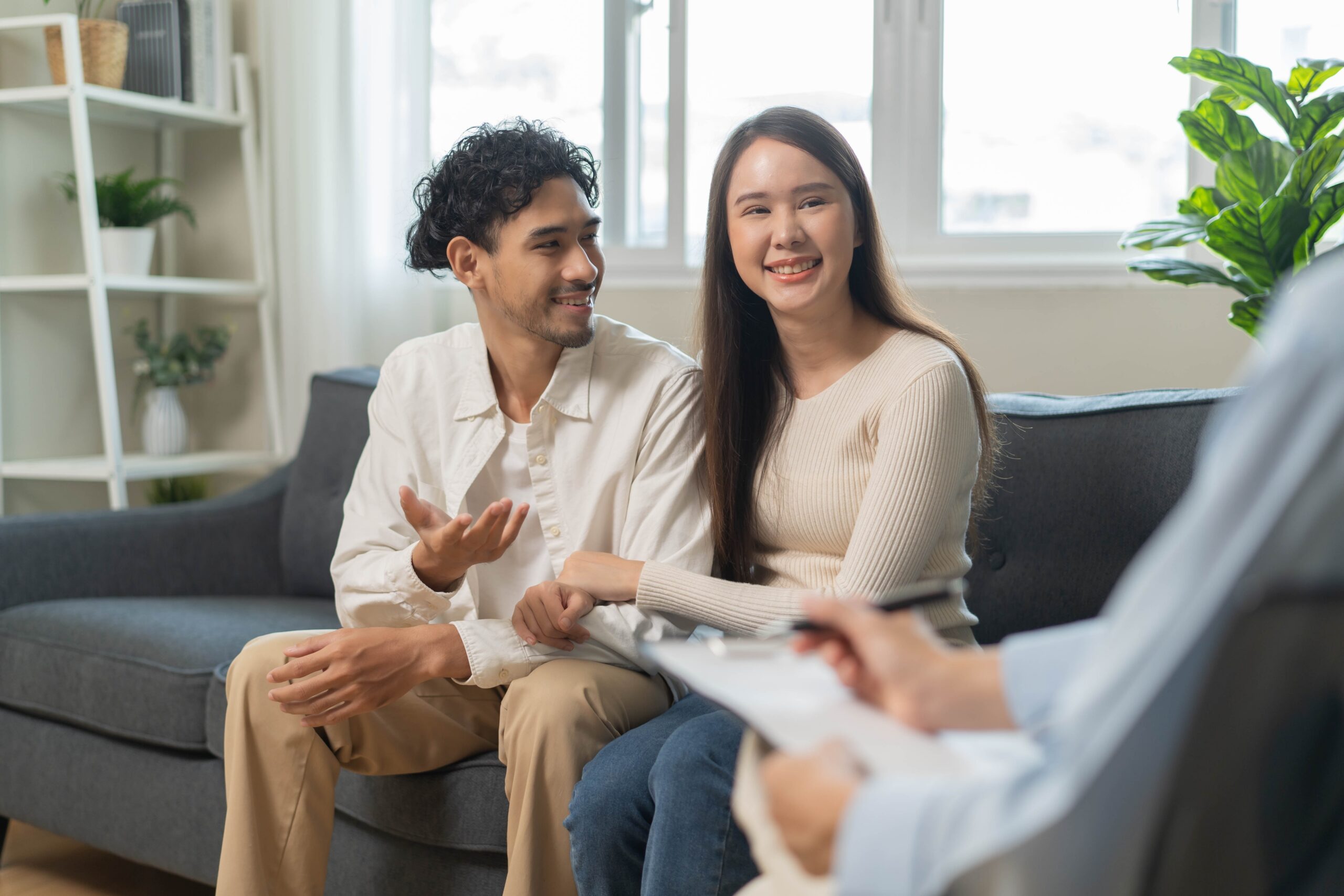 Young Asian couple sitting in a counseling session.