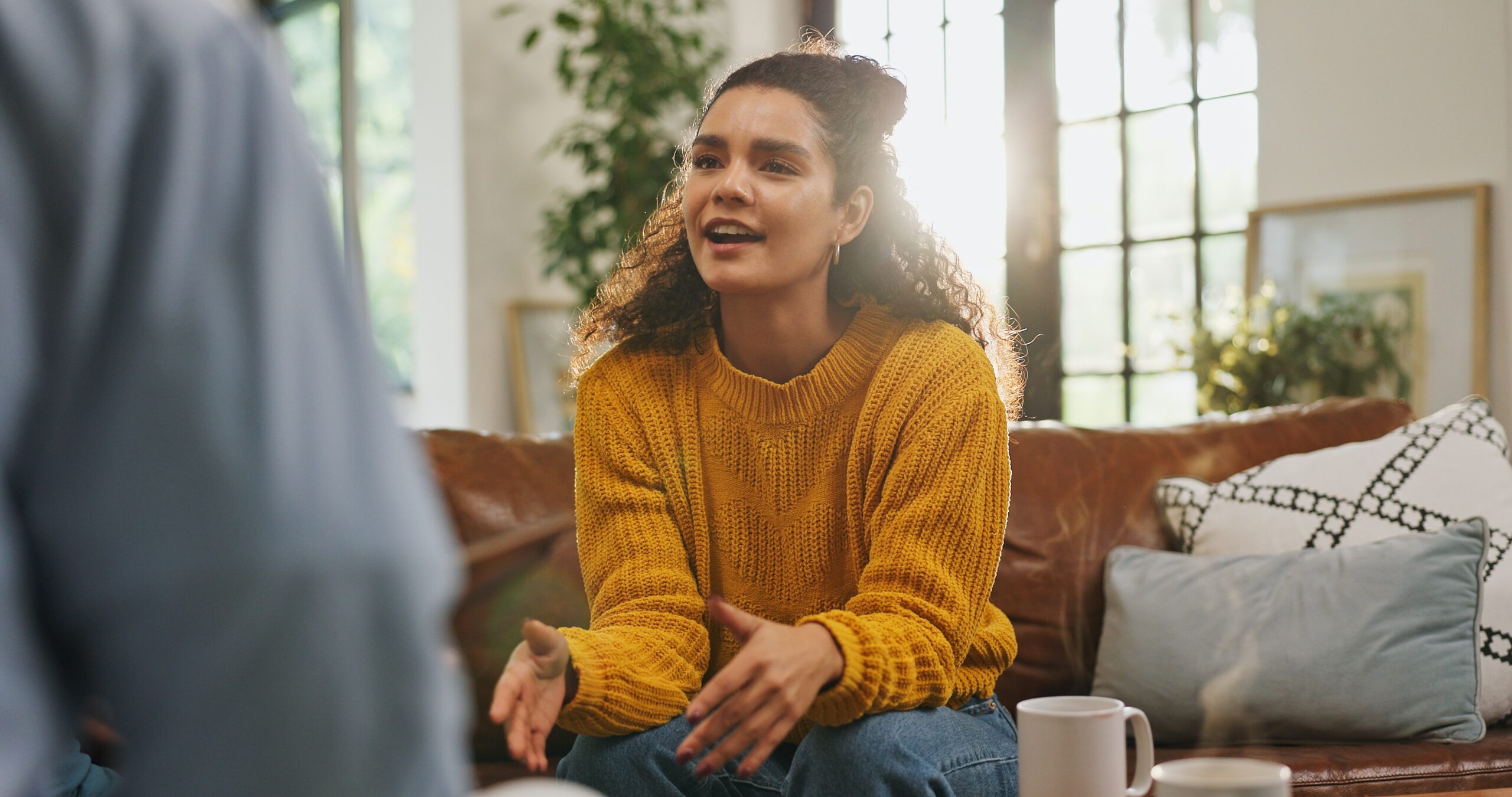 young woman sitting and talking to a therapist.